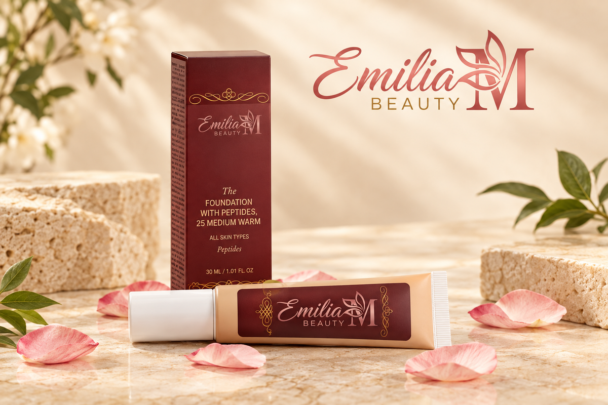Emilia M Beauty Foundation with Peptides in 25 Medium Warm displayed with its burgundy box on a beige stone setting with pink petals