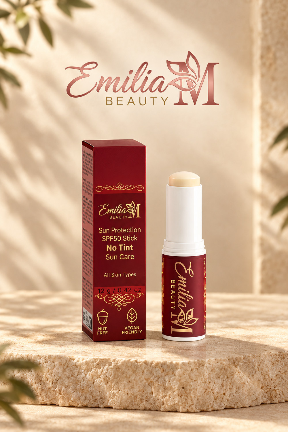 Emilia M Beauty Sun Protection SPF50 Stick No Tint standing beside its burgundy box on a stone surface